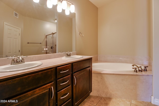 bathroom featuring tile patterned flooring, vanity, and shower with separate bathtub