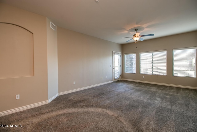 carpeted spare room with ceiling fan