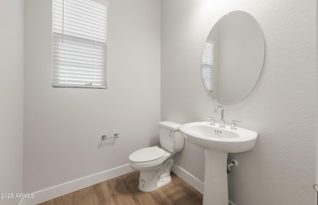 22660 E Pegasus Pkwy, Queen Creek, AZ 85142 - bathroom featuring baseboards, wood finished floors, and toilet