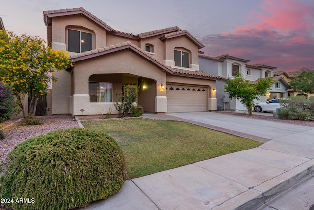 20293 N 83rd Dr, Peoria, AZ 85382 - mediterranean / spanish-style home with a tiled roof, a yard, a garage, concrete driveway, and stucco siding