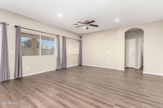 20293 N 83rd Dr, Peoria, AZ 85382 - unfurnished living room with visible vents, wood finished floors, recessed lighting, arched walkways, and a ceiling fan
