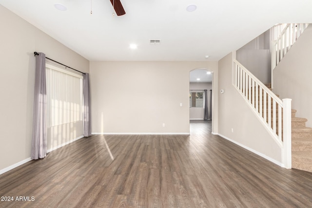 unfurnished living room with ceiling fan and dark hardwood / wood-style flooring