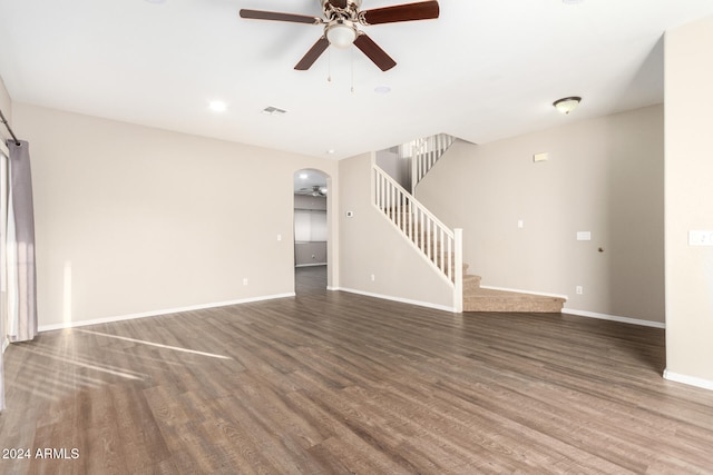 unfurnished living room featuring ceiling fan and dark hardwood / wood-style flooring