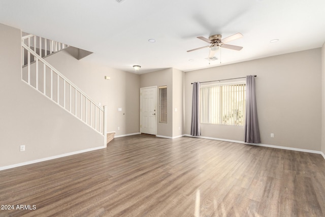 unfurnished living room with ceiling fan and wood-type flooring