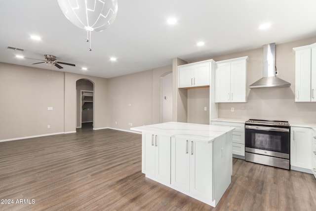 kitchen featuring a center island, electric range, white cabinetry, wall chimney exhaust hood, and dark wood-type flooring