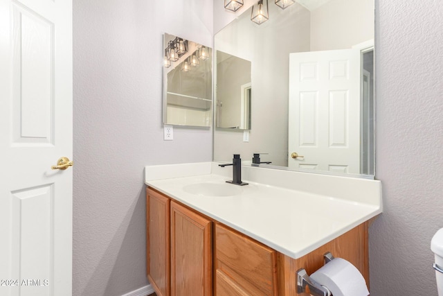 20293 N 83rd Dr, Peoria, AZ 85382 - bathroom with vanity, a textured wall, and toilet