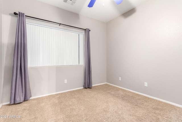 unfurnished room with light carpet and ceiling fan