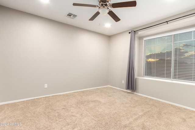 carpeted empty room with ceiling fan