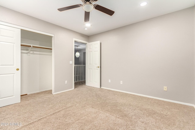 unfurnished bedroom with carpet, a closet, and ceiling fan