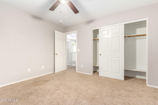 unfurnished bedroom with light carpet, a closet, and ceiling fan