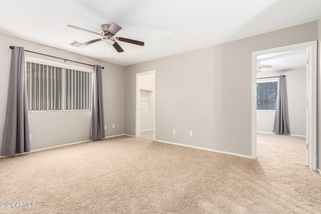 carpeted empty room with ceiling fan