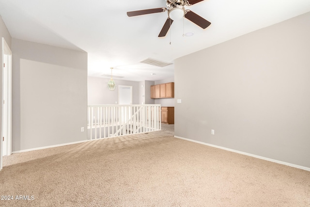 empty room with light carpet and ceiling fan