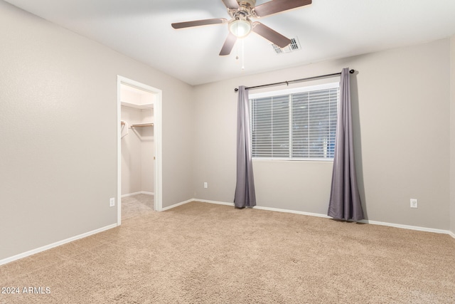 spare room featuring light carpet and ceiling fan