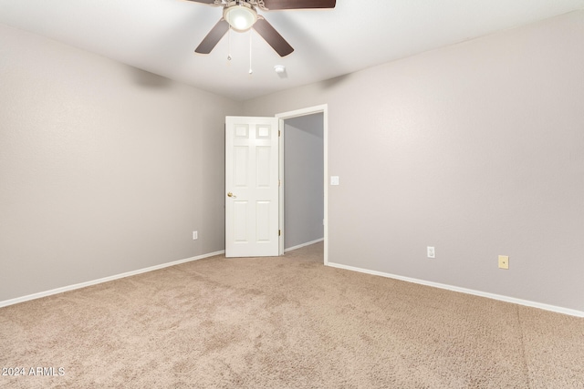 unfurnished room featuring ceiling fan and carpet floors