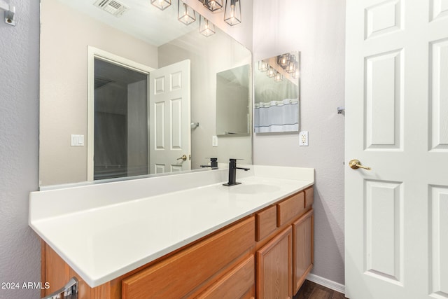 bathroom with vanity and hardwood / wood-style flooring