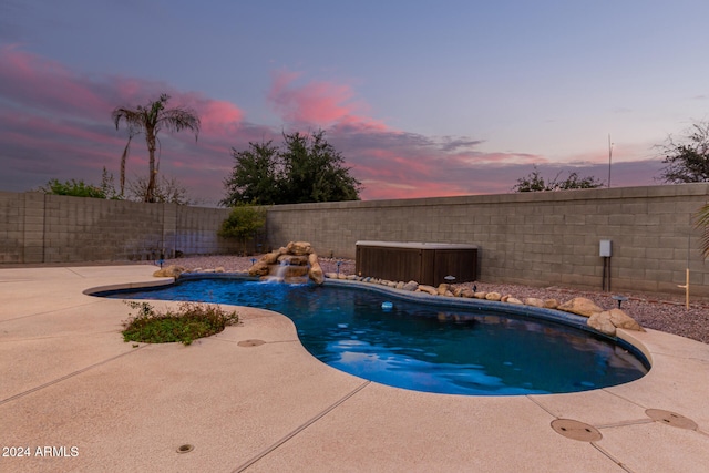 pool at dusk featuring central air condition unit, a patio area, and pool water feature