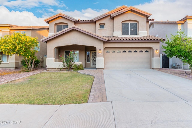 20293 N 83rd Dr, Peoria, AZ 85382 - mediterranean / spanish-style home featuring a garage, a front lawn, stucco siding, and a tiled roof