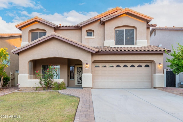 20293 N 83rd Dr, Peoria, AZ 85382 - mediterranean / spanish-style house featuring a garage, stucco siding, a tiled roof, and driveway
