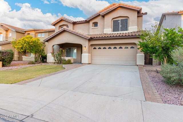 20293 N 83rd Dr, Peoria, AZ 85382 - mediterranean / spanish home with driveway, a tile roof, a front lawn, an attached garage, and stucco siding