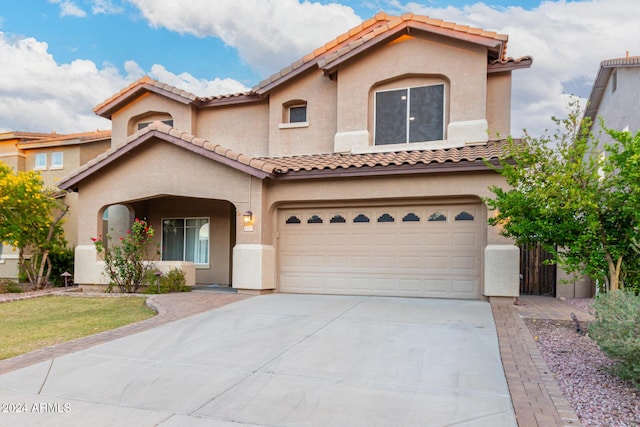 20293 N 83rd Dr, Peoria, AZ 85382 - mediterranean / spanish-style house featuring a tiled roof, an attached garage, driveway, and stucco siding