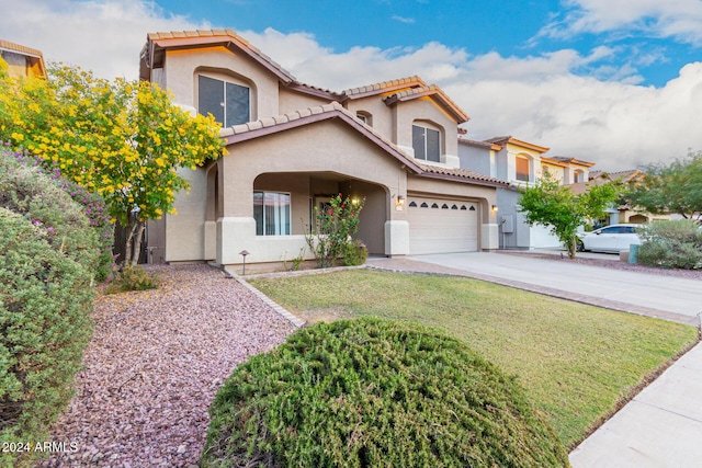 20293 N 83rd Dr, Peoria, AZ 85382 - mediterranean / spanish-style home with a tile roof, a garage, stucco siding, a front yard, and driveway