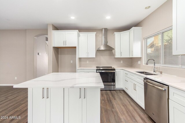 20293 N 83rd Dr, Peoria, AZ 85382 - kitchen featuring a center island, a sink, dark wood-style floors, stainless steel appliances, and wall chimney exhaust hood