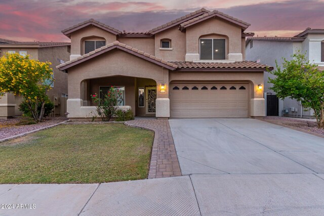 20293 N 83rd Dr, Peoria, AZ 85382 - mediterranean / spanish house with concrete driveway, stucco siding, a front lawn, and a tile roof