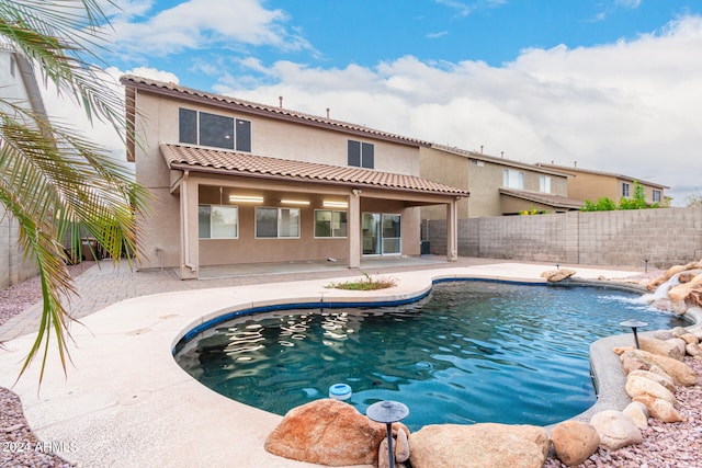 view of pool with a patio and pool water feature