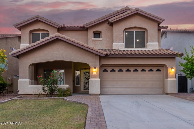 20293 N 83rd Dr, Peoria, AZ 85382 - mediterranean / spanish home with driveway, stucco siding, a tiled roof, an attached garage, and a yard