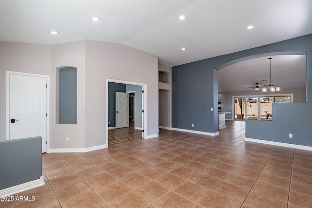 unfurnished living room featuring tile patterned flooring, vaulted ceiling, ceiling fan, and built in shelves