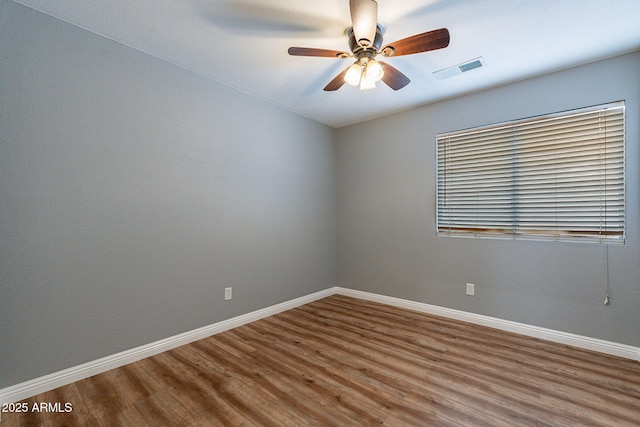 spare room with hardwood / wood-style flooring and ceiling fan