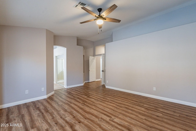 unfurnished room with ceiling fan, lofted ceiling, and wood-type flooring