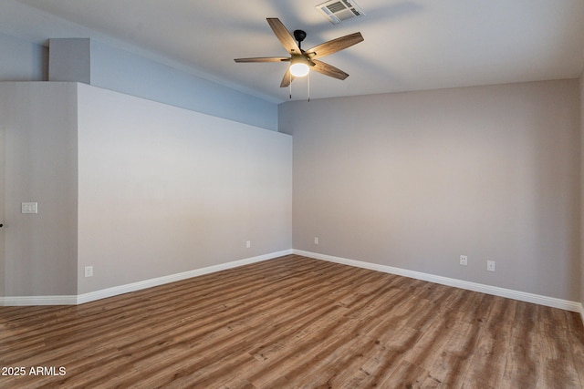 empty room with hardwood / wood-style floors and ceiling fan