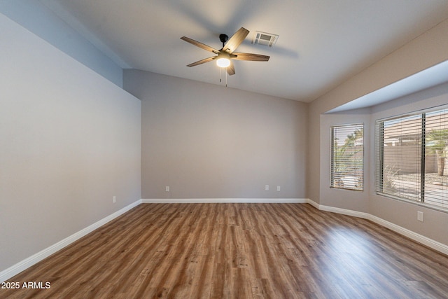 spare room featuring vaulted ceiling, wood-type flooring, and ceiling fan