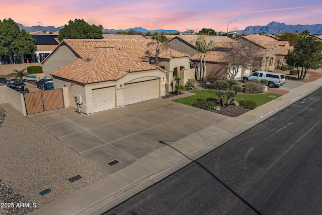 view of front of property with a garage and a mountain view