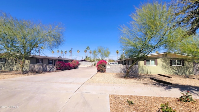 exterior space featuring driveway and a fenced front yard