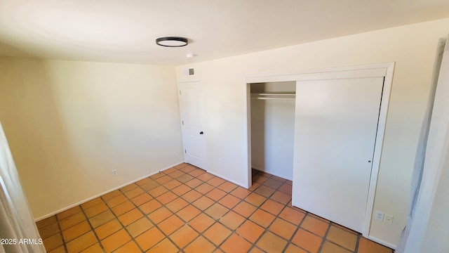 unfurnished bedroom with a closet and visible vents