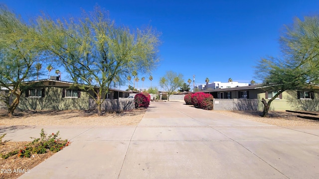 exterior space with a fenced front yard and concrete driveway