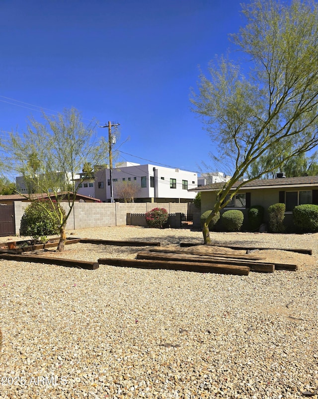 view of front of home featuring fence