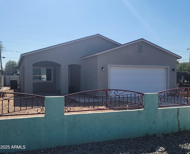 view of front of property with central AC and a garage