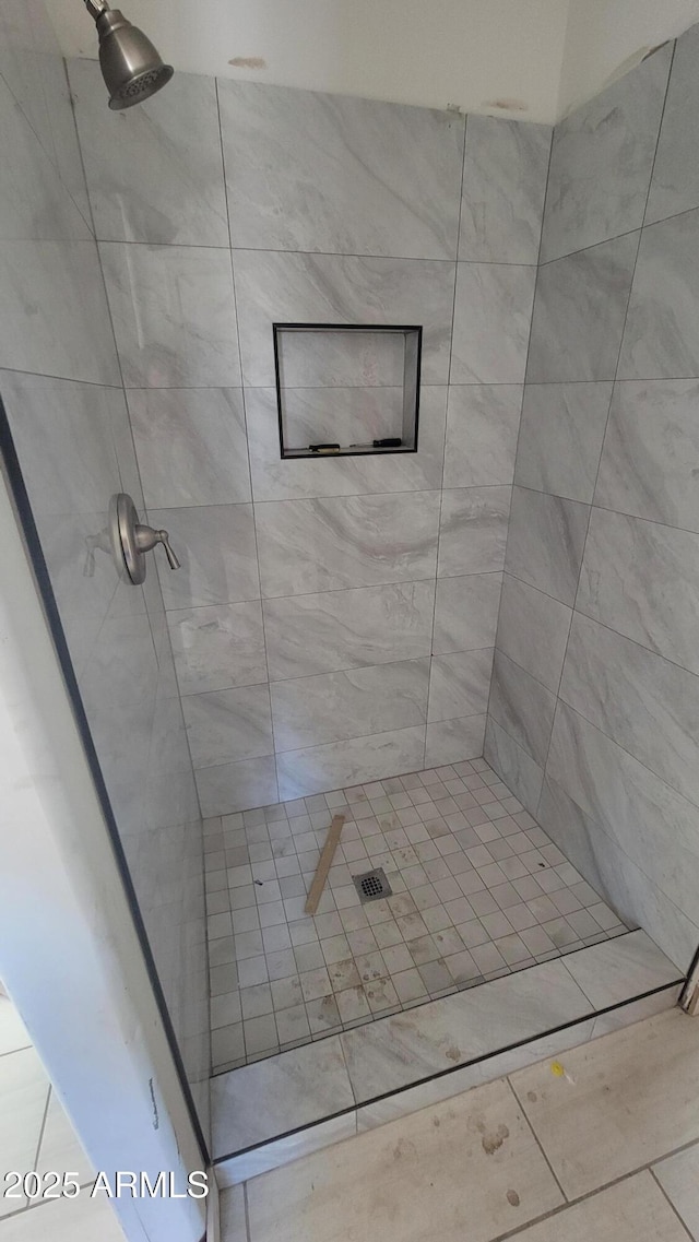 bathroom with a tile shower