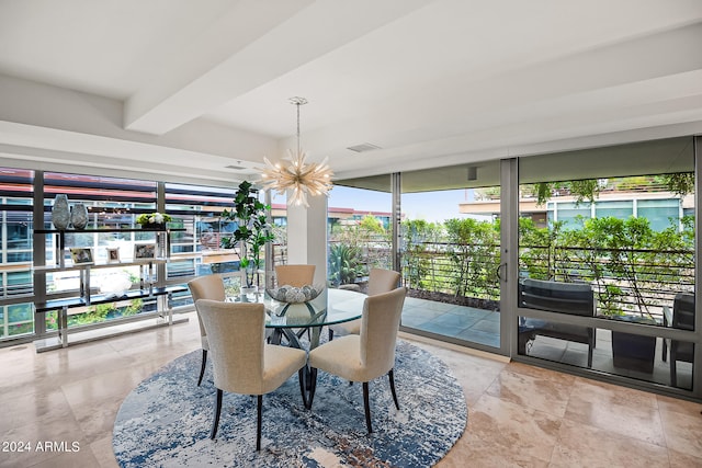 dining area with a wall of windows and an inviting chandelier