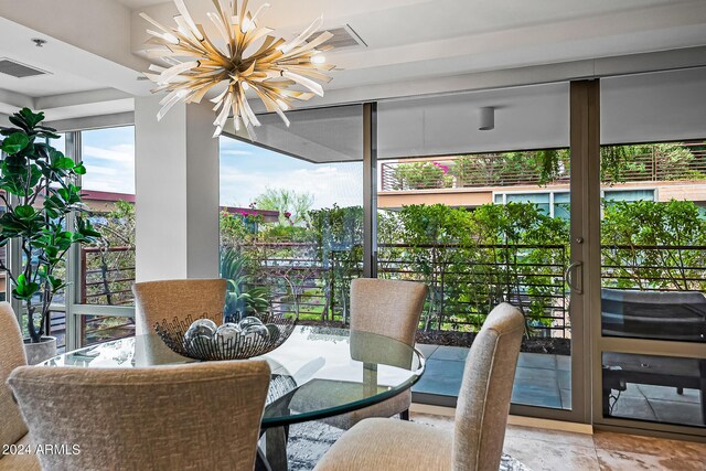 dining space with sink and a notable chandelier