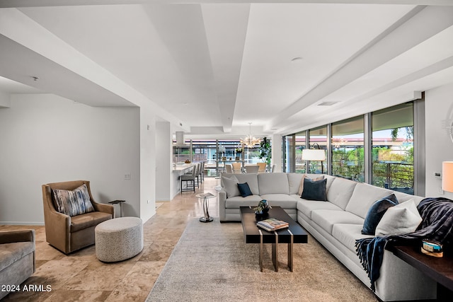 living room featuring a notable chandelier and plenty of natural light