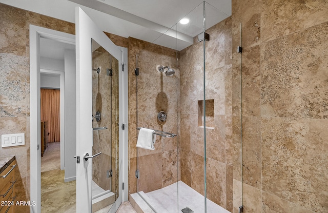 bathroom featuring vanity and an enclosed shower