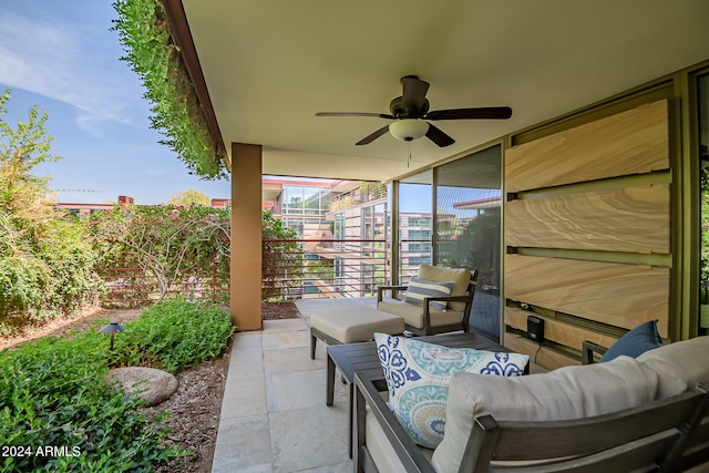 view of patio with an outdoor living space and ceiling fan