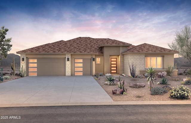 18716 N 269th Ln, Buckeye, AZ 85396 - view of front of home featuring a garage, stucco siding, concrete driveway, and stone siding