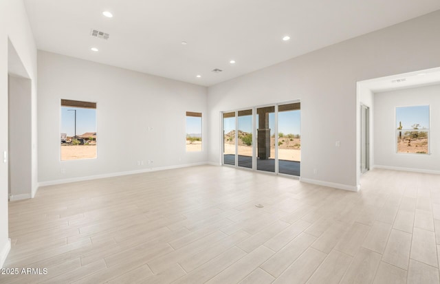18716 N 269th Ln, Buckeye, AZ 85396 - spare room featuring plenty of natural light, light wood finished floors, baseboards, and recessed lighting