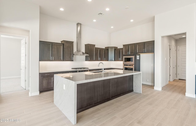 18716 N 269th Ln, Buckeye, AZ 85396 - kitchen featuring wall chimney exhaust hood, stainless steel appliances, a sink, baseboards, and recessed lighting