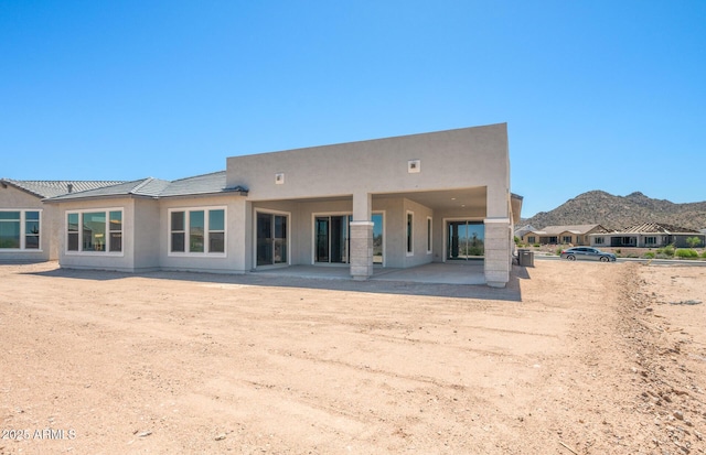 18716 N 269th Ln, Buckeye, AZ 85396 - rear view of property featuring stucco siding, a mountain view, and a patio area